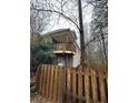 A fenced backyard with a covered deck offers a private outdoor space to relax at 217 Spalding Gates Dr, Atlanta, GA 30328