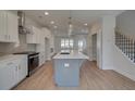 Bright open kitchen showcases an island, stainless steel appliances, and white cabinetry at 3316 Cranston Ln, Kennesaw, GA 30144