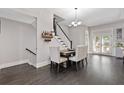 Dining area features a wooden table and chairs with a wine rack displayed on the adjacent wall at 482 Pearl Cove Ct, Atlanta, GA 30350