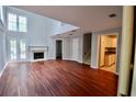 Bright living room featuring hardwood floors, fireplace, and large windows offering ample natural light at 5065 Avalon Dr, Alpharetta, GA 30005