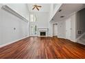 Bright living room with a fireplace, hardwood floors, and high ceilings create a welcoming atmosphere at 5065 Avalon Dr, Alpharetta, GA 30005