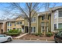 View of well-maintained townhouse, including landscaping and a parking area out front for residents and guests at 5065 Avalon Dr, Alpharetta, GA 30005