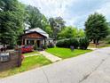 Inviting home with lush green lawn and red flowers lining the walkway at 657 S Grand Nw Ave, Atlanta, GA 30318