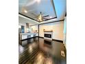 Open-concept living room with fireplace, dark hardwood floors, and a view of the kitchen at 657 S Grand Nw Ave, Atlanta, GA 30318