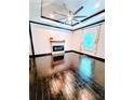 Stylish living room featuring hardwood floors, tray ceilings, a modern fireplace, and abundant natural light at 657 S Grand Nw Ave, Atlanta, GA 30318