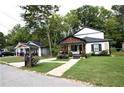 Quaint street view with a charming two-story home and manicured front lawn at 657 S Grand Nw Ave, Atlanta, GA 30318