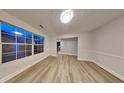 Bright living room featuring wood-look floors, large window, and a fresh, neutral palette at 805 Kilkenny Cir, Lithonia, GA 30058