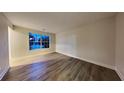 Spacious living room featuring wood-look floors and a fresh, neutral palette at 805 Kilkenny Cir, Lithonia, GA 30058