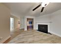 Inviting living room featuring wood-look floors and a fireplace at 805 Kilkenny Cir, Lithonia, GA 30058