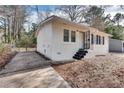 A cozy, newly painted white brick home with a well-kept yard and private driveway at 895 Mercury Nw Dr, Atlanta, GA 30331
