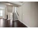 Inviting entryway with dark wood floors, staircase, and natural light at 2499 Village Park Bend, Duluth, GA 30096