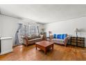 Cozy living room with hardwood floors, neutral walls, two sofas, and a vintage wooden coffee table at 2671 Lee Ann Dr, Marietta, GA 30066