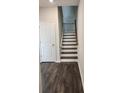 View of a staircase with dark wood treads, white risers, and a modern metal handrail at 3765 Davis Cir, Duluth, GA 30096