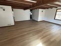 Open-concept living area with beamed ceilings, hardwood floors, and abundant natural light at 690 Antioch Rd, Powder Springs, GA 30127