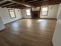 Spacious living room with beamed ceiling, hardwood floors and a stone fireplace at 690 Antioch Rd, Powder Springs, GA 30127