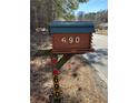 Unique log-style mailbox featuring the house number 690 on a wooden post at 690 Antioch Rd, Powder Springs, GA 30127
