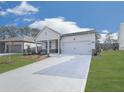 Charming single-story home with a two-car garage, professionally landscaped front yard, and long driveway at 3614 Arrow Root Cir, Loganville, GA 30052