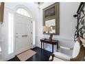 Elegant foyer with white walls, dark wood floors, and a statement mirror, leading to the rest of the home at 2525 Peachtree Ne Rd # 25, Atlanta, GA 30305