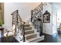Beautiful staircase with unique iron railings and patterned carpet, enhancing the home's character at 2525 Peachtree Ne Rd # 25, Atlanta, GA 30305