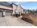 Exterior view of a house with a lush lawn, and a two car garage at 2971 Montview Sw Dr, Marietta, GA 30060