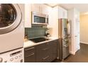 Contemporary kitchen design with stainless steel refrigerator, built-in microwave, and in-unit washer/dryer at 1101 Juniper Ne St # 721, Atlanta, GA 30309