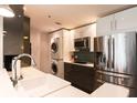 Modern kitchen featuring stainless steel appliances, white countertops, and a convenient in-unit washer/dryer at 1101 Juniper Ne St # 721, Atlanta, GA 30309
