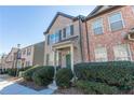 Charming two-story brick townhome features well-maintained landscaping along a sidewalk at 1830 Bayrose Cir # 30B, East Point, GA 30344