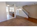 Open-concept living room showcasing the staircase and view into the kitchen at 1830 Bayrose Cir # 30B, East Point, GA 30344