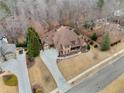 An aerial view shows this house's placement in a wooded cul-de-sac with an in-ground pool at 829 Waterford Estates Mnr, Canton, GA 30115