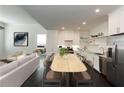 An open kitchen and living area features stainless steel appliances and ample counter space at 10625 Serenbe Ln # 208, Chattahoochee Hills, GA 30268