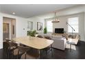 Bright living and dining area features modern decor, hardwood floors and plenty of natural light from large windows at 10625 Serenbe Ln # 208, Chattahoochee Hills, GA 30268