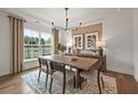 Bright dining room features modern chandelier, natural light, and stylish decor at 1605 Wander Ml, Cumming, GA 30040