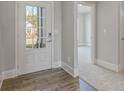 Inviting foyer featuring wood-look flooring and a view into a brightly lit room at 38 Lakeview Pt, Dallas, GA 30157
