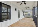 Inviting covered balcony featuring wood flooring, dark railings, and stylish exterior lighting fixtures at 727 Garibaldi Sw St, Atlanta, GA 30310
