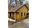 Angle shot of home showing covered porch, driveway, and garage with basketball hoop at 110 Casa Domain Ct, South Fulton, GA 30349
