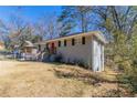 Charming single-story home showcasing its side and front exterior with trees and a sloped yard at 2202 Polar Rock Sw Pl, Atlanta, GA 30315