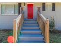 Inviting front entrance with a bright red door, gray steps, and light-colored brick at 2202 Polar Rock Sw Pl, Atlanta, GA 30315