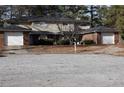 Two-story townhome with brick accents, attached garages, and mature trees in a residential neighborhood at 2788 Coventry Se Grn, Conyers, GA 30013