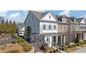 Charming two-story house with a cozy porch, manicured landscaping, and a traditional architectural style at 122 Brighton Blvd, Woodstock, GA 30188