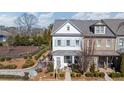 Inviting two-story house with a cozy front porch, landscaped yard, and light blue shutters at 122 Brighton Blvd, Woodstock, GA 30188
