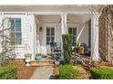 Inviting front porch with comfortable seating, potted plants, and classic white columns at 122 Brighton Blvd, Woodstock, GA 30188