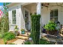 Charming front porch enhanced by potted plants, stone steps, and a welcoming entrance at 122 Brighton Blvd, Woodstock, GA 30188
