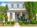 Inviting front porch features classic columns, neatly trimmed shrubs, and a cozy seating area at 122 Brighton Blvd, Woodstock, GA 30188