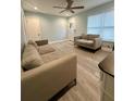 Bright living room featuring neutral paint, modern ceiling fan, and new wood floors at 172 Scarsdale Dr, Riverdale, GA 30274