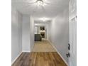 Bright entryway with hardwood floors leading to a cozy living room with a fireplace at 6336 Lake Valley Pt, Lithonia, GA 30058