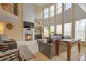 Sunlit living room featuring soaring ceilings, fireplace, and large windows at 3162 Abbey Sw Dr, Atlanta, GA 30331