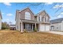 Lovely two-story home featuring a brick and siding facade, a covered porch, and a two-car garage at 4022 Rosebud Park Dr, Snellville, GA 30039