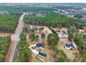 Expansive aerial view of the property showcasing its wooded surroundings and neighborhood in a tranquil, rural setting at 2705 Luke Edwards Rd, Dacula, GA 30019