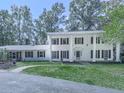 Traditional two-story white home with black shutters, pillars, and a well-manicured lawn at 633 Butterworth Rd, Canton, GA 30114