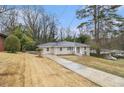 A single-story home with a long driveway, showcasing its classic and simple design at 2328 Starline Dr, Decatur, GA 30032